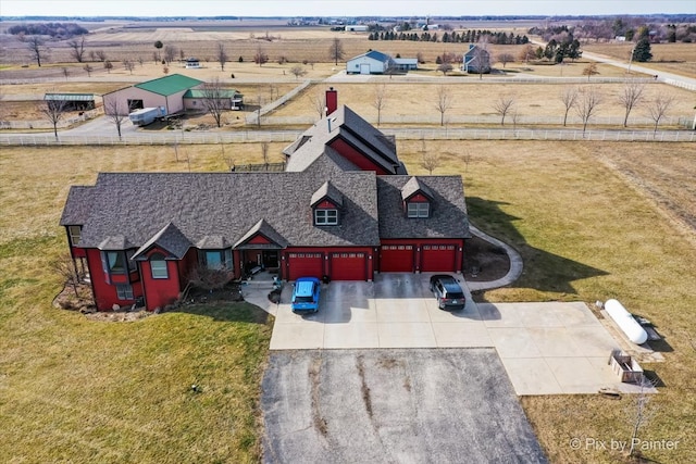 birds eye view of property with a rural view