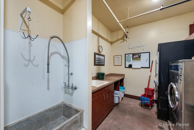 kitchen featuring washer / clothes dryer and sink