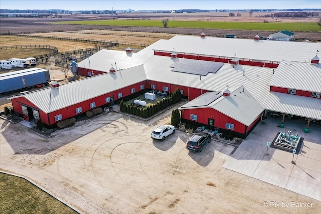 birds eye view of property with a rural view