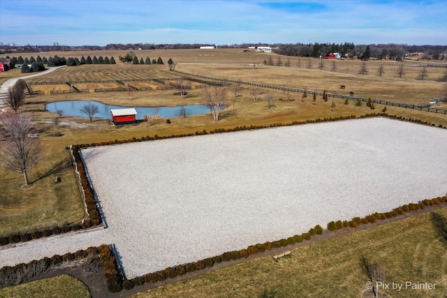 birds eye view of property featuring a rural view and a water view