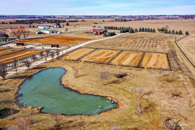 birds eye view of property with a rural view and a water view