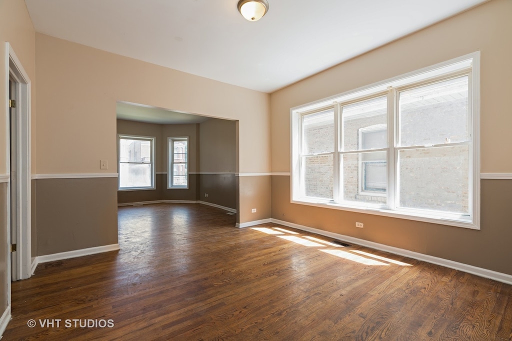 empty room with dark wood-type flooring