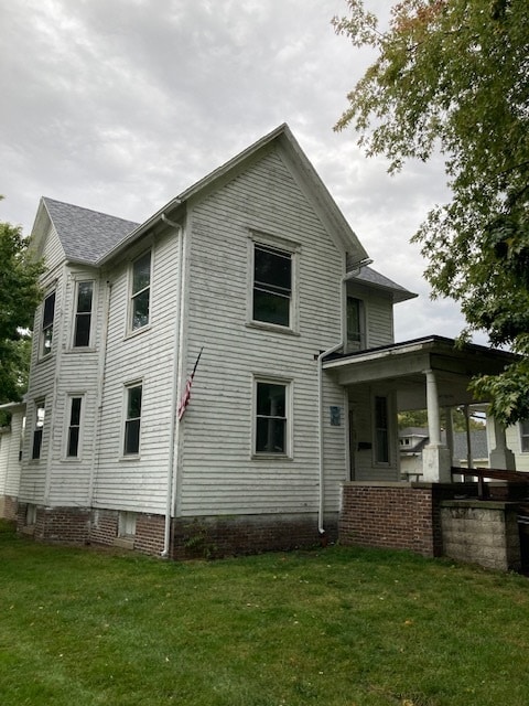 rear view of house with a yard