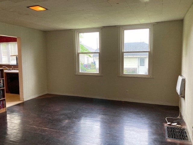 spare room featuring dark hardwood / wood-style flooring