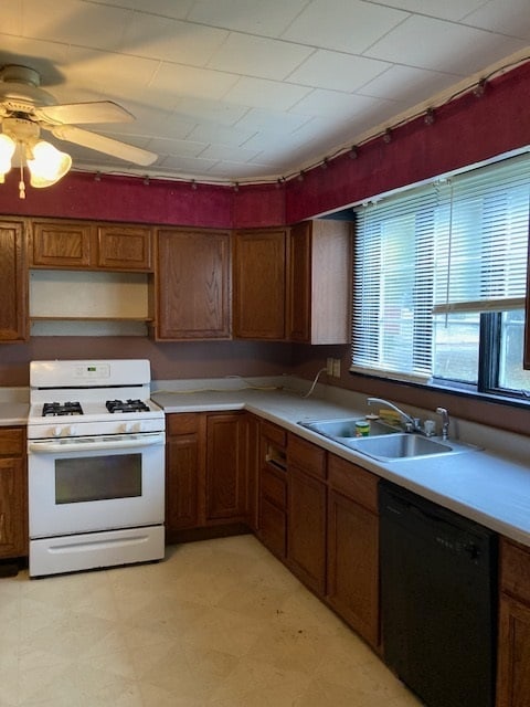 kitchen with ceiling fan, light tile floors, white gas stove, dishwasher, and sink