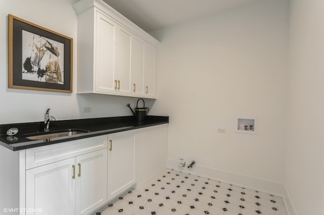 laundry room with sink, cabinets, hookup for a washing machine, and light tile patterned floors