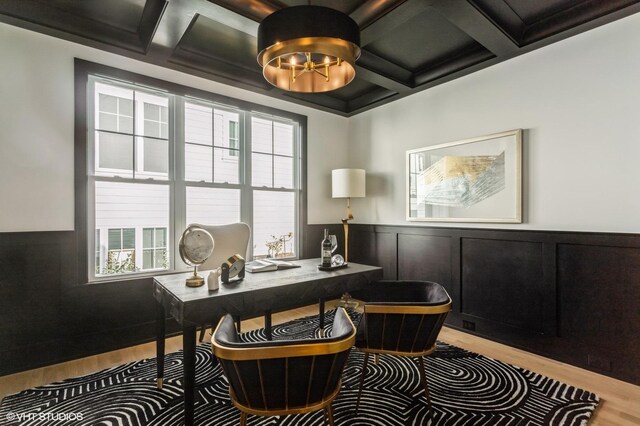 home office with light wood-type flooring and coffered ceiling