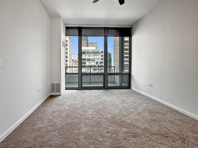 spare room with carpet floors and ceiling fan