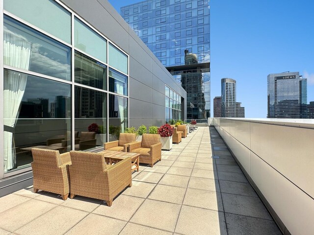 view of patio / terrace with a balcony and an outdoor living space