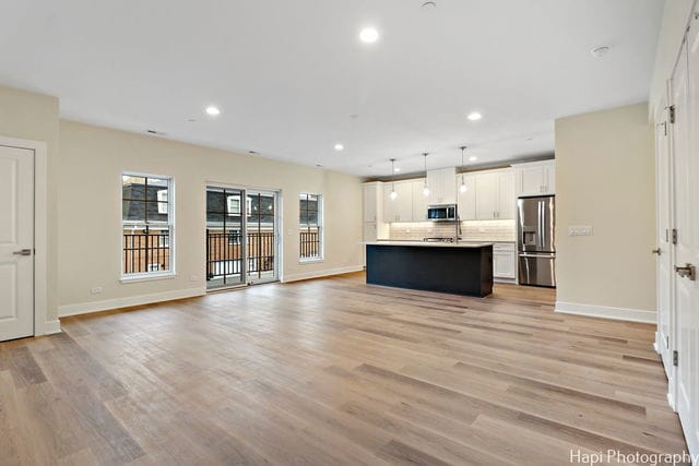 unfurnished living room with light wood-type flooring