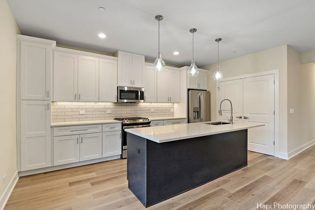 kitchen featuring white cabinets, stainless steel appliances, and sink