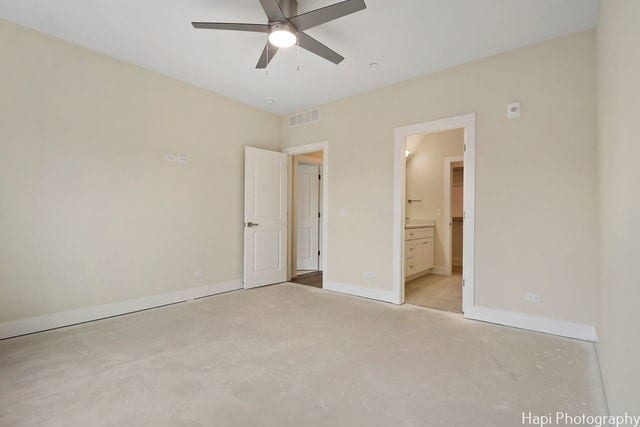 unfurnished bedroom with ensuite bathroom and ceiling fan