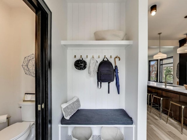 2457 N Talman Ave, Chicago, IL 60647 - mudroom featuring a sink, light wood finished floors, and wooden walls