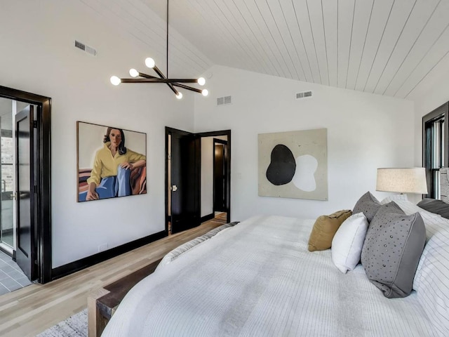 2457 N Talman Ave, Chicago, IL 60647 - bedroom with lofted ceiling, wood finished floors, and a chandelier
