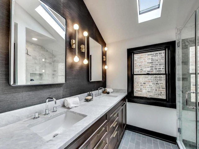 2457 N Talman Ave, Chicago, IL 60647 - full bath with a skylight, lofted ceiling, double vanity, a shower stall, and tile patterned floors