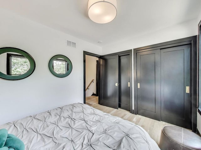 2457 N Talman Ave, Chicago, IL 60647 - bedroom featuring two closets and light wood-style flooring