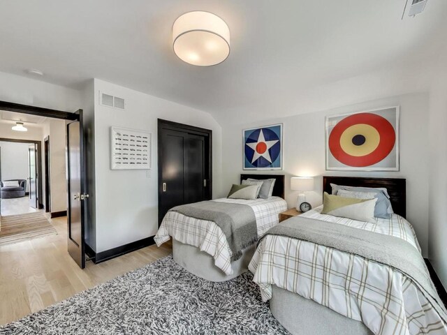 2457 N Talman Ave, Chicago, IL 60647 - bedroom featuring light wood-style flooring, baseboards, and a closet