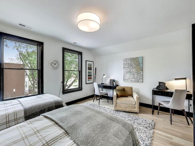 2457 N Talman Ave, Chicago, IL 60647 - bedroom with light wood finished floors, an office area, baseboards, and lofted ceiling