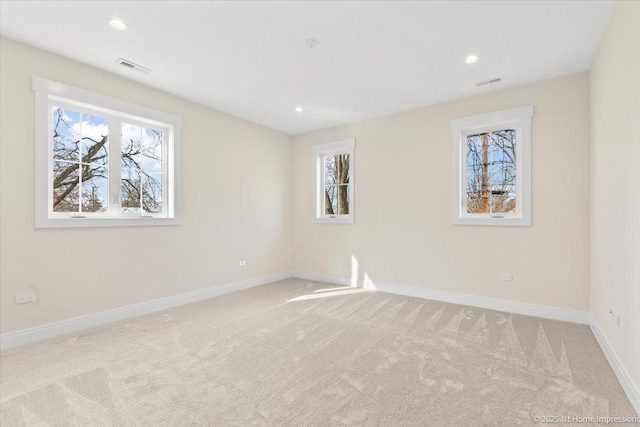 unfurnished room featuring light carpet, baseboards, visible vents, and recessed lighting