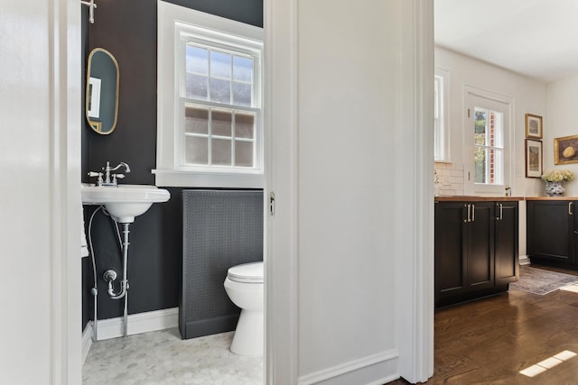 298 Dickens St, Northfield, IL 60093 - bathroom featuring toilet, baseboards, and wood finished floors