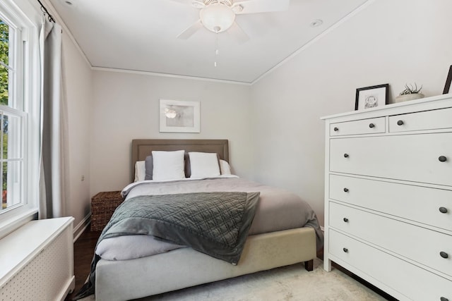 298 Dickens St, Northfield, IL 60093 - bedroom featuring radiator heating unit, ceiling fan, ornamental molding, light wood-type flooring, and baseboards
