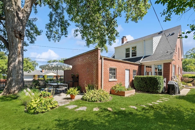 298 Dickens St, Northfield, IL 60093 - rear view of property with brick siding, a chimney, and a patio