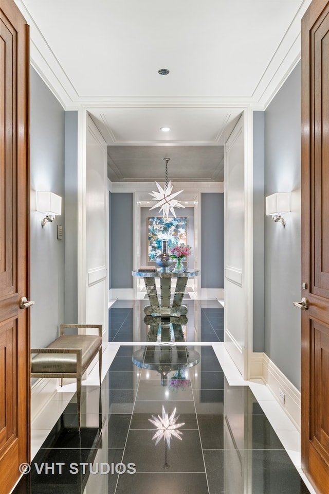 hall featuring dark tile floors and crown molding