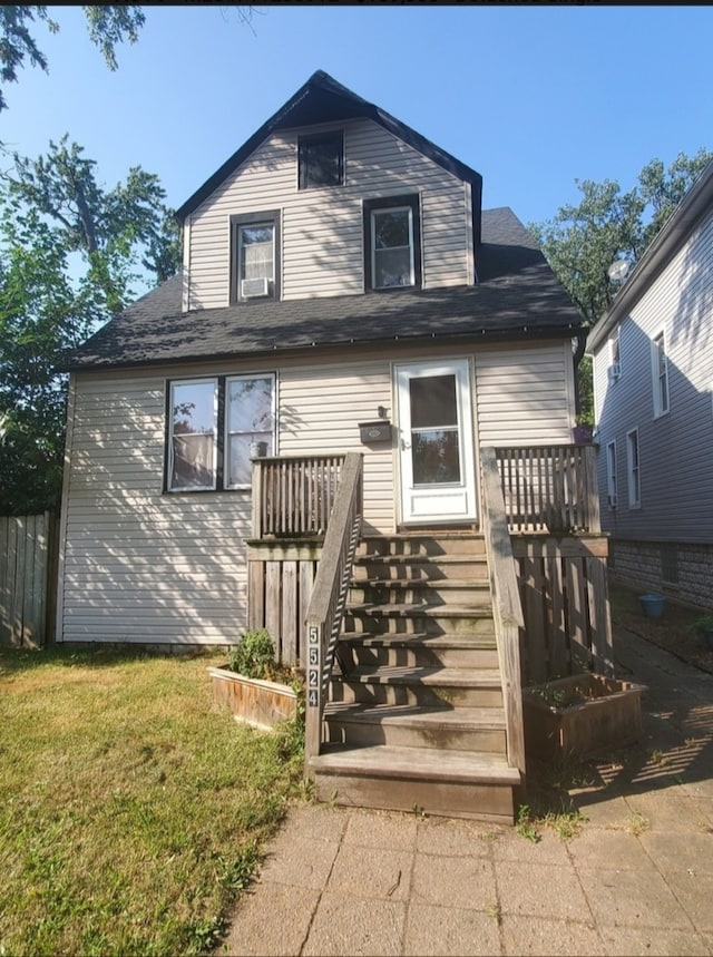 exterior space with a wooden deck and a front lawn