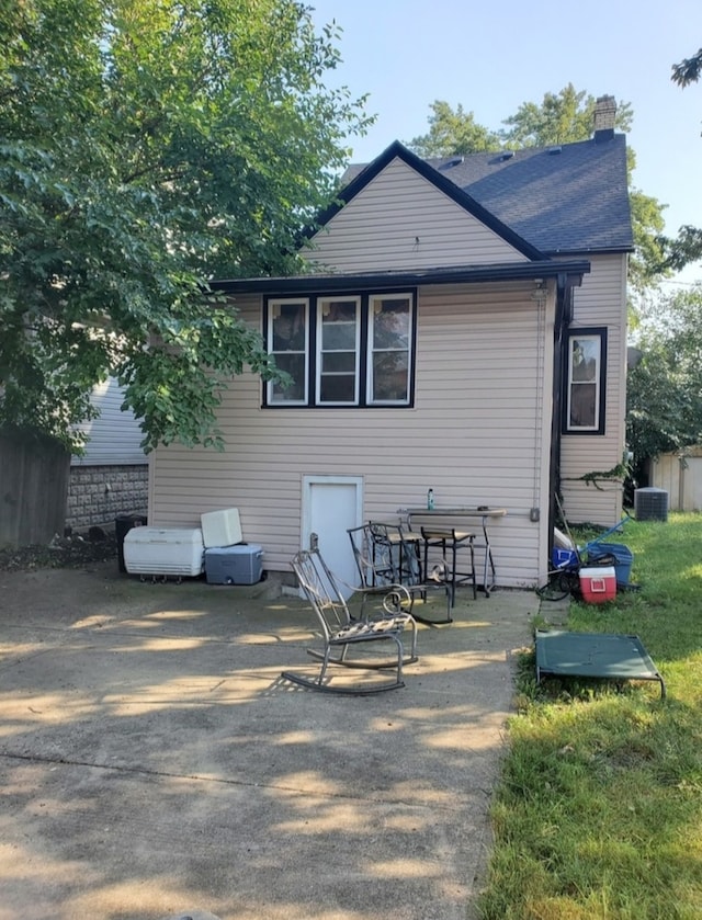 back of property featuring central AC unit and a patio