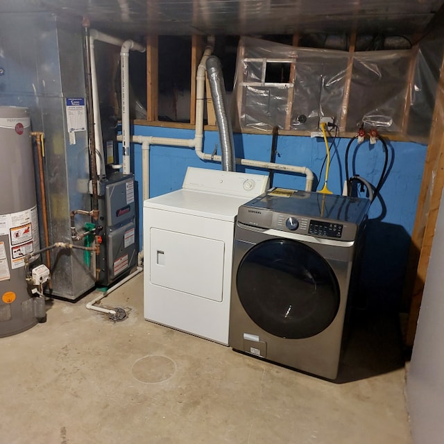 clothes washing area with water heater, washer and dryer, and hookup for a washing machine