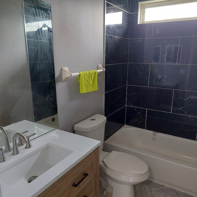 full bathroom with vanity, tile flooring, toilet, and tiled shower / bath