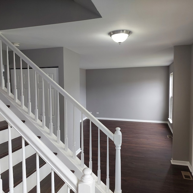 staircase with dark hardwood / wood-style flooring