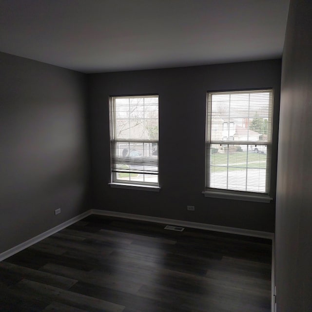 unfurnished room featuring dark hardwood / wood-style flooring