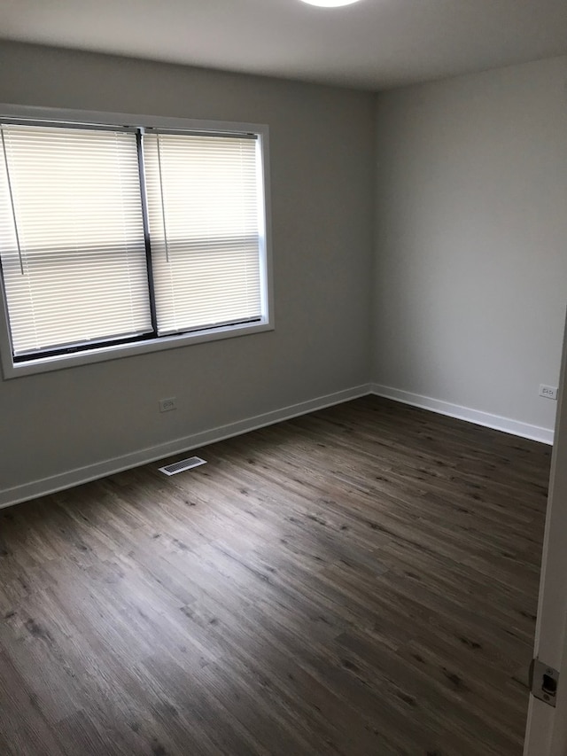 spare room with dark hardwood / wood-style flooring