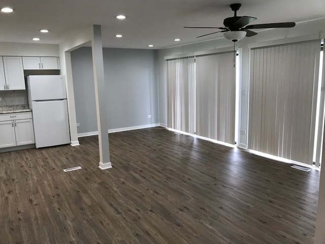 empty room featuring dark hardwood / wood-style flooring and ceiling fan