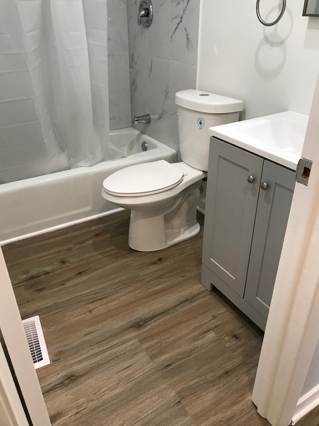 full bathroom with vanity, toilet, shower / bath combo, and hardwood / wood-style flooring