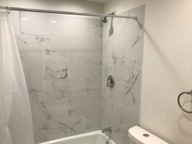 bathroom with toilet and shower / bathtub combination with curtain