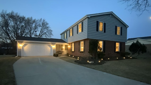 view of front of property featuring a garage, brick siding, and concrete driveway