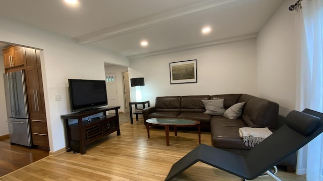 living room featuring beamed ceiling, recessed lighting, light wood-style floors, and baseboards