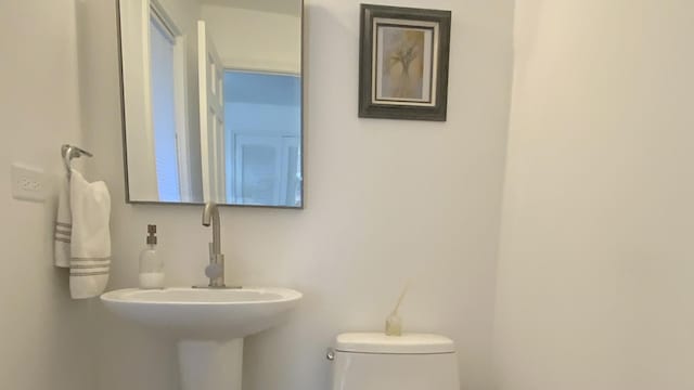 half bathroom with a sink and toilet