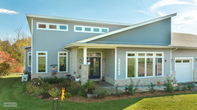 view of front of property featuring a garage and a front yard