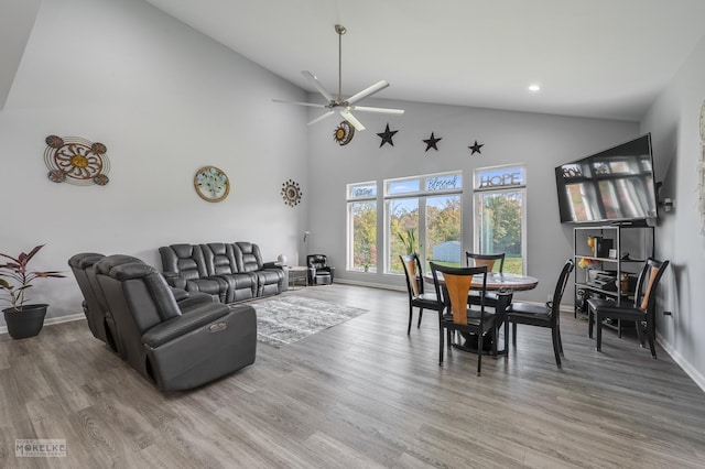 dining room featuring high vaulted ceiling, ceiling fan, and hardwood / wood-style floors