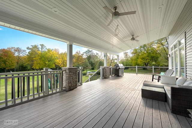 wooden deck with ceiling fan, a grill, and an outdoor living space