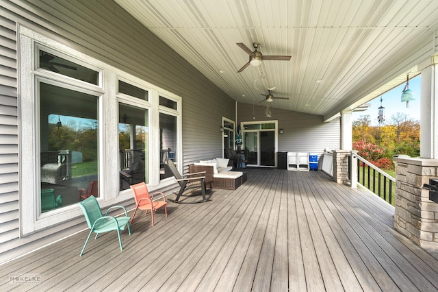 deck featuring ceiling fan and an outdoor living space