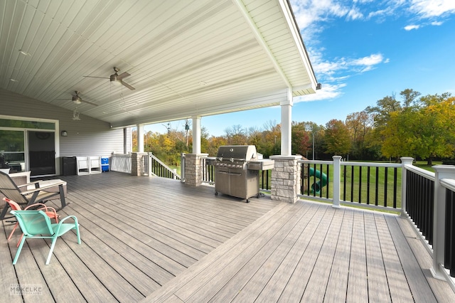 wooden terrace with ceiling fan and area for grilling