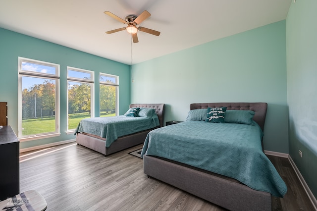 bedroom with ceiling fan and light wood-type flooring