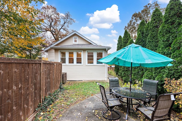 back of property with a patio and central AC unit