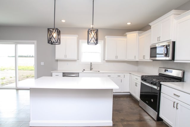 kitchen with a wealth of natural light, stainless steel appliances, decorative backsplash, and dark hardwood / wood-style floors