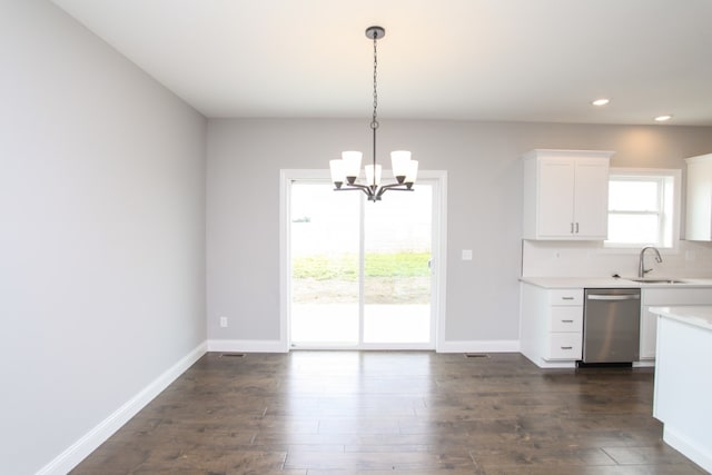 unfurnished dining area featuring dark hardwood / wood-style flooring, a notable chandelier, and sink