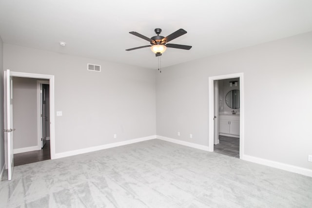 carpeted empty room with ceiling fan and sink